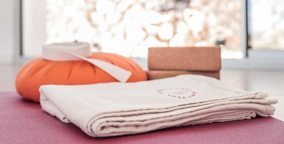 Eine Yogamatte, Yogahandtuch, Yogabolster und Yogablöcke